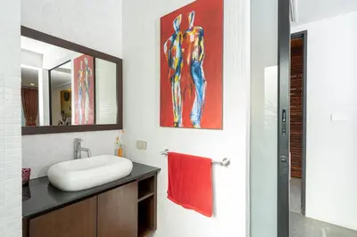 a bathroom with a sink and a red towel at The Thara Villa Surin Beach in Surin Beach