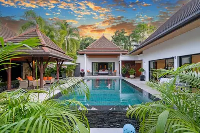 an exterior view of a villa with a swimming pool at The Thara Villa Surin Beach in Surin Beach