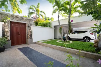 a car parked in front of a house with a garage at The Thara Villa Surin Beach in Surin Beach