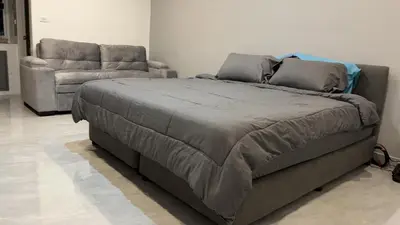 a large bed and a couch in a room at Patong Vacation Rentals - Located in the Heart of Patong, Studio Apartments walking distance to the beach, King Bed, Kitchen, Private Bathroom, Seating Area, 65
