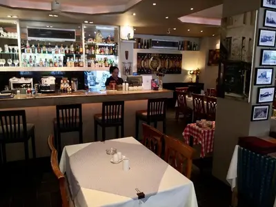 a dining room with a table and a bar at Patong Vacation Rentals - Located in the Heart of Patong, Studio Apartments walking distance to the beach, King Bed, Kitchen, Private Bathroom, Seating Area, 65