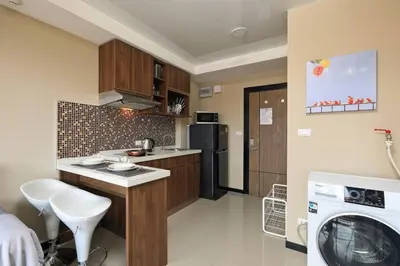 a kitchen with a washer and dryer in a room at New Condo NaiHarn Beach by Capital Pro in Phuket Town