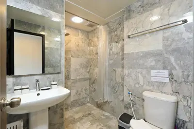 a bathroom with a sink and a toilet and a mirror at New Condo NaiHarn Beach by Capital Pro in Phuket Town