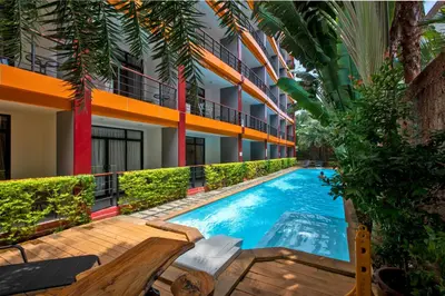 a swimming pool in front of a building at Naiharn Sea Condo by Capital Pro in Phuket Town