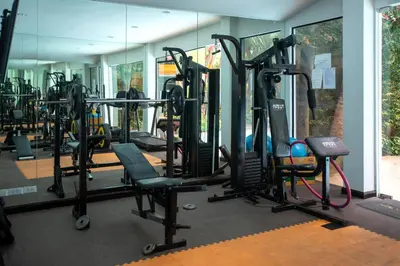 a gym with a lot of treadmills and machines at 1bdr Apartment Naiharn Beach Condo by CapitalPro in Phuket Town