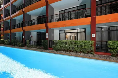 an apartment building with a swimming pool in front of it at 1bdr Pool Access Studio on NaiHarn Beach by Capital Pro in Phuket Town