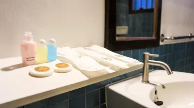 a bathroom with two bottles of soap and a sink at Ban Raya Resort and Spa in Ko Racha Yai