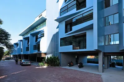 a white building with motorcycles parked outside of it at 1bdr Apartment Relife Naiharn by Capital Pro in Phuket Town