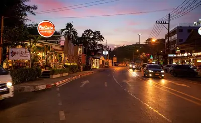 a city street at night with cars driving down the street at 1bdr Apartment Relife Naiharn by Capital Pro in Phuket Town