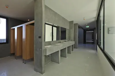 a bathroom with three sinks and a row of mirrors at 1bdr Apartment ReLife Windy Naiharn by CapitalPro in Phuket Town