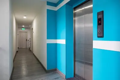 a hallway with blue and white stripes on the wall at iCheck inn Chill Patong in Patong Beach