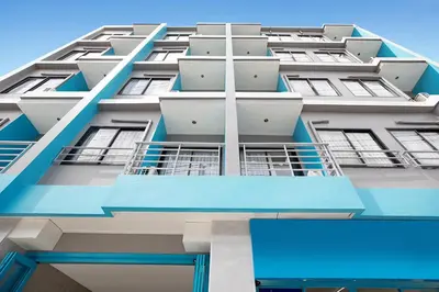 a tall apartment building with blue balconies at iCheck inn Chill Patong in Patong Beach