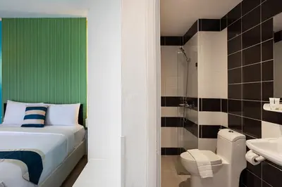 a bathroom with a bed and a toilet and a shower at iCheck inn Chill Patong in Patong Beach
