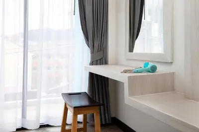 a room with a shelf and a mirror and a stool at iCheck inn Chill Patong in Patong Beach