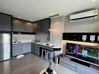 a kitchen with stainless steel appliances and a tv at Kamala Beach P53 Exclusive Junior Suite in Kamala Beach