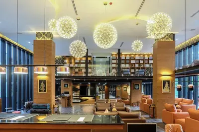 a large library with couches and chairs and chandeliers at Kamala Beach P53 Exclusive Junior Suite in Kamala Beach