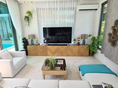 a living room with a couch and a tv at Villa Mimosa 2, Splendid 3 Bedroom Master Ensuite in Phuket Town