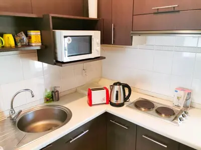 a kitchen counter with a sink and a microwave at Best Location Patong Near Jungceylon + Pool Access in Patong Beach
