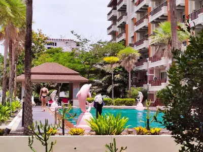 a resort with a swimming pool with statues of flamingos at Best Location Patong Near Jungceylon + Pool Access in Patong Beach