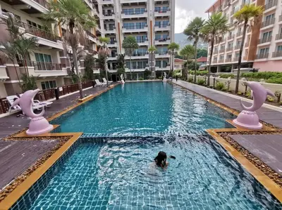 a person swimming in a swimming pool in a building at Best Location Patong Near Jungceylon + Pool Access in Patong Beach