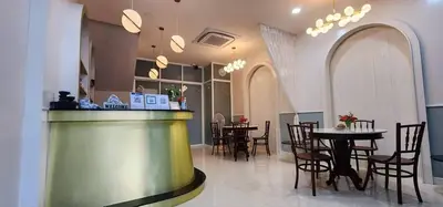 a restaurant with a bar and tables and chairs at PPhouse Boutique House Phuket Town in Ban Bang Khu