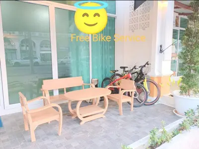 a patio with a table and chairs and a smiley face sign at PPhouse Boutique House Phuket Town in Ban Bang Khu