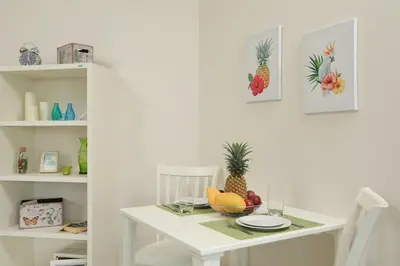 a white table with a bowl of fruit on it at 1bdr Apartment with bath in Chic Condo By Capital Pro in Phuket Town