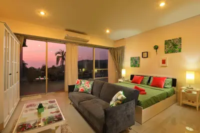 a living room with a couch and a bed at 1bdr Apartment with bath in Chic Condo By Capital Pro in Phuket Town