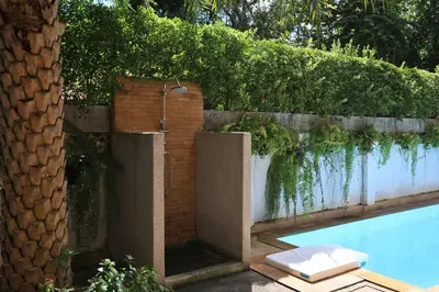 a swimming pool next to a brick wall with a swimming pool at New apartment Rawai Beach 310 by Capital Pro in Phuket Town