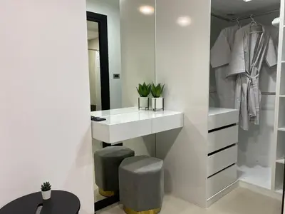 a bathroom with a white vanity and a sink and stool at New apartment Rawai Beach 310 by Capital Pro in Phuket Town