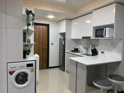 a kitchen with a washing machine and a counter at New apartment Rawai Beach 310 by Capital Pro in Phuket Town