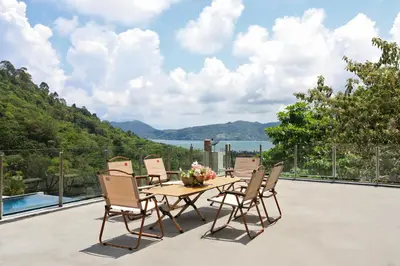 a table and chairs on a patio with a view at Dolphin Villa in Patong Beach