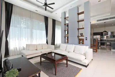 a living room with a white couch and a table at Dolphin Villa in Patong Beach