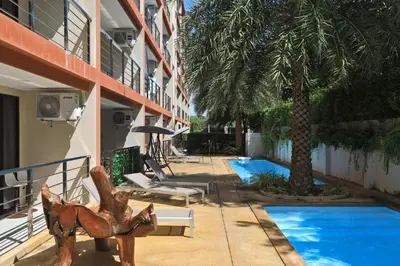 a resort with a swimming pool next to a building at New apartment Rawai Beach 218 by Capital Pro in Phuket Town