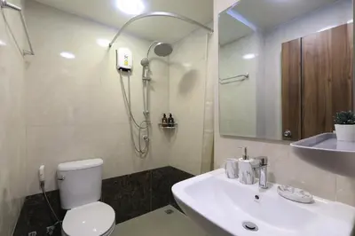 a bathroom with a toilet and a sink and a shower at New apartment Rawai Beach 218 by Capital Pro in Phuket Town