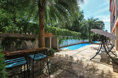 a patio with a table and chairs next to a pool at New apartment Rawai Beach 218 by Capital Pro in Phuket Town