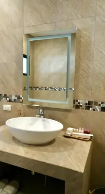 a bathroom with a white sink and a mirror at Jasmine Village in Rawai Beach
