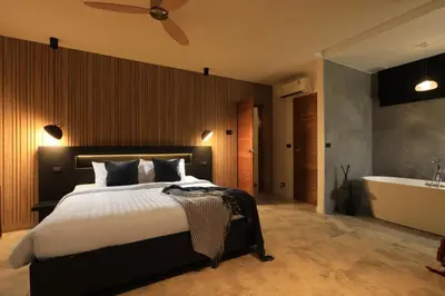 a bedroom with a bed and a bath tub at New 4 bedroom pool villa in Rawai by Capital Pro in Phuket Town