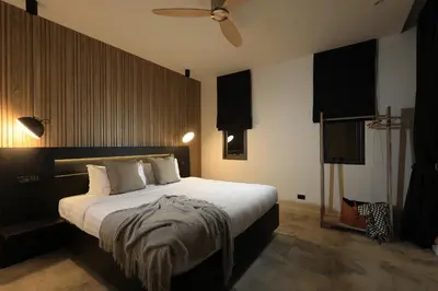 a bedroom with a large bed and a tv at New 4 bedroom pool villa in Rawai by Capital Pro in Phuket Town