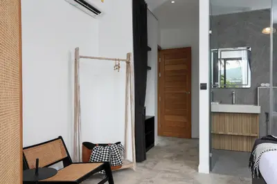 a bedroom with a door leading to a bathroom at New 4 bedroom pool villa in Rawai by Capital Pro in Phuket Town