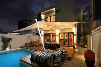 a house with a swimming pool next to a house at New 4 bedroom pool villa in Rawai by Capital Pro in Phuket Town