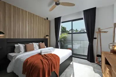 a bedroom with a bed and a large window at New 4 bedroom pool villa in Rawai by Capital Pro in Phuket Town