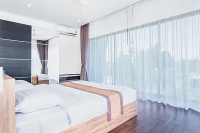 a bedroom with a bed and a large window at 2bdr pool villa in Rawai by Capital Pro SUM-20-144 in Phuket Town