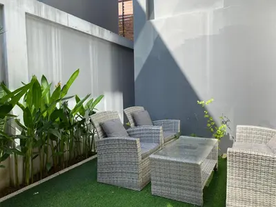 a patio with wicker chairs and a table and plants at 2bdr pool villa in Rawai by Capital Pro SUM-20-144 in Phuket Town