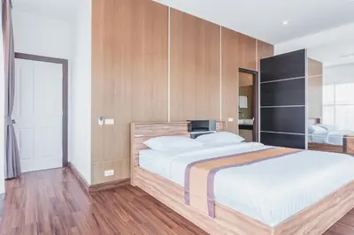 a bedroom with a large bed with wooden walls at 2bdr pool villa in Rawai by Capital Pro SUM-20-144 in Phuket Town