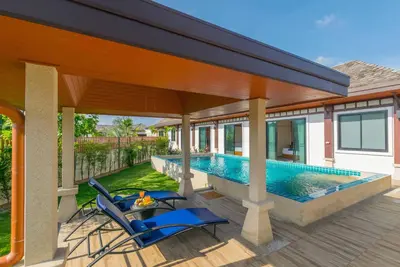a patio with two chairs and a swimming pool at 3bdr VIP Villa Rawai with private pool in Phuket Town