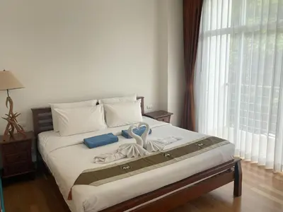 a bed with towels and a pair of scissors on it at Spacious apartment Kamala Falls by Lofty in Kamala Beach