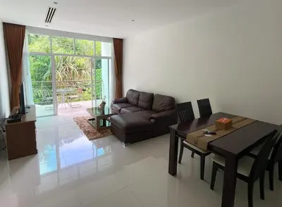 a living room with a couch and a table at Spacious apartment Kamala Falls by Lofty in Kamala Beach