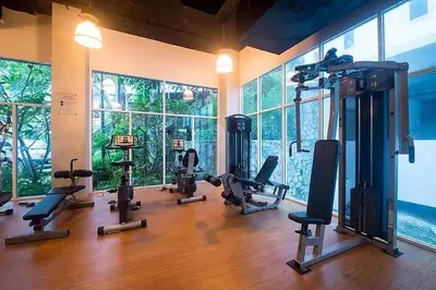 a gym with a bunch of exercise equipment in a room at Spacious apartment Kamala Falls by Lofty in Kamala Beach