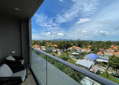 a balcony with a view of a city at Mountain view apartment in the heart of BangTao in Bang Tao Beach